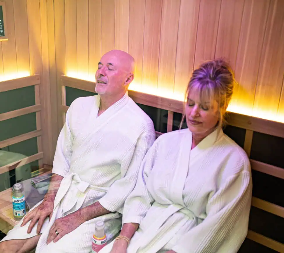 Two people sitting in a sauna